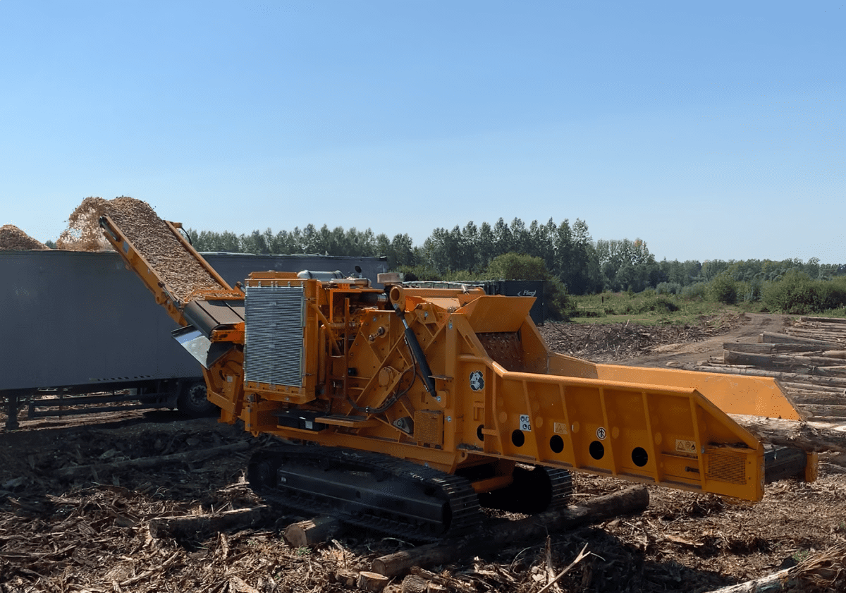 CBI 5400 processing wood waste in a field