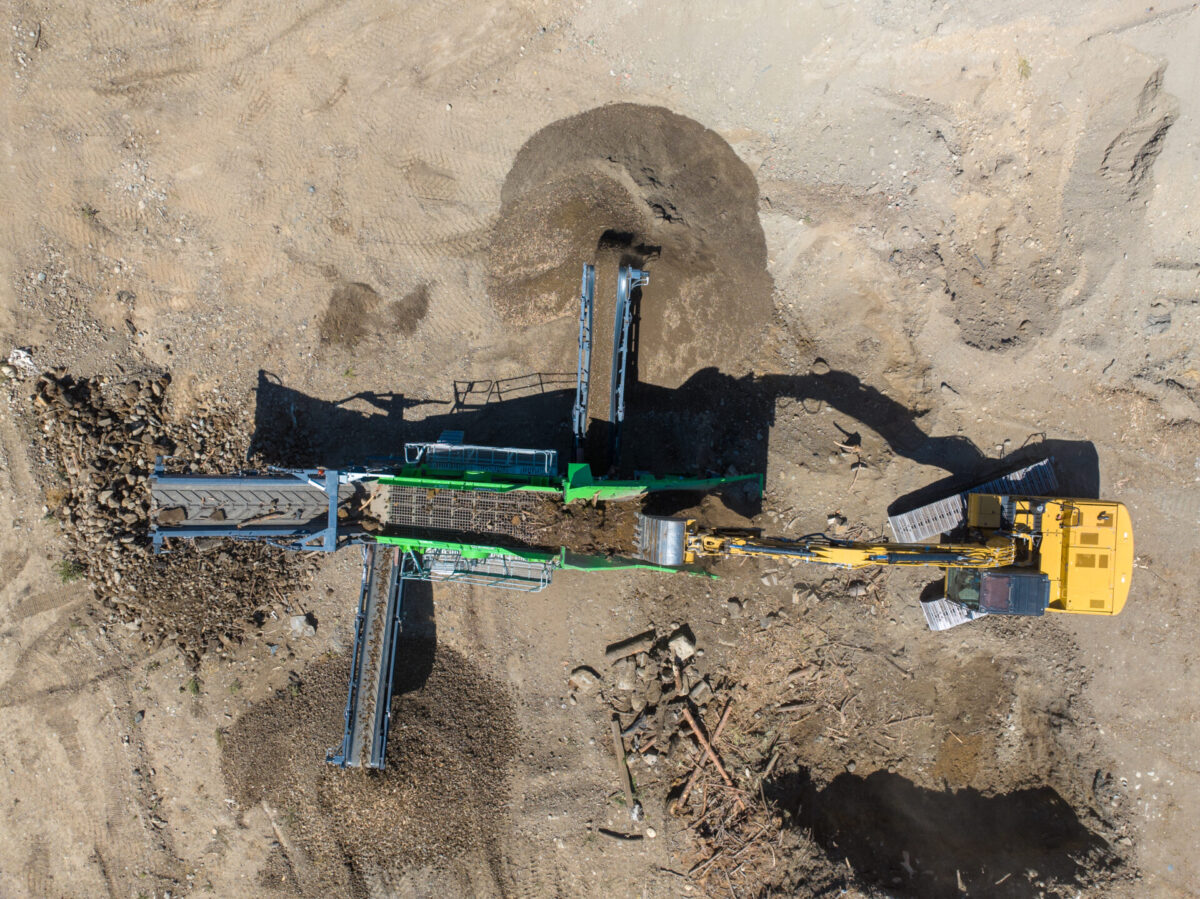 Evoquip Colt 1000 screener screening dirt into usable topsoil in a field