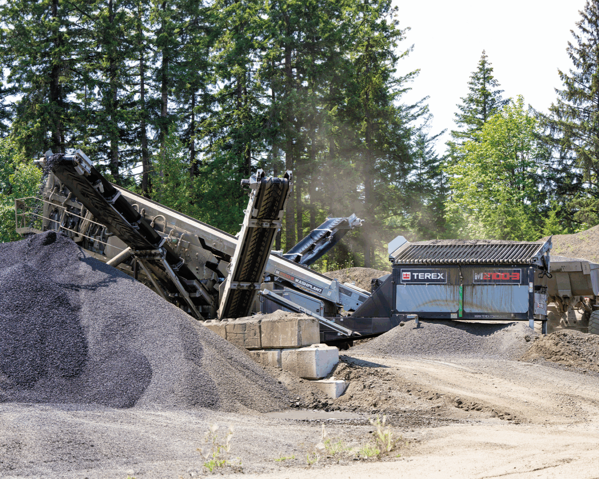 Terex Washing Systems M2100-3 wash plant screening and washing aggregate at a quarry site, producing clean stone and sand stockpiles for construction applications.