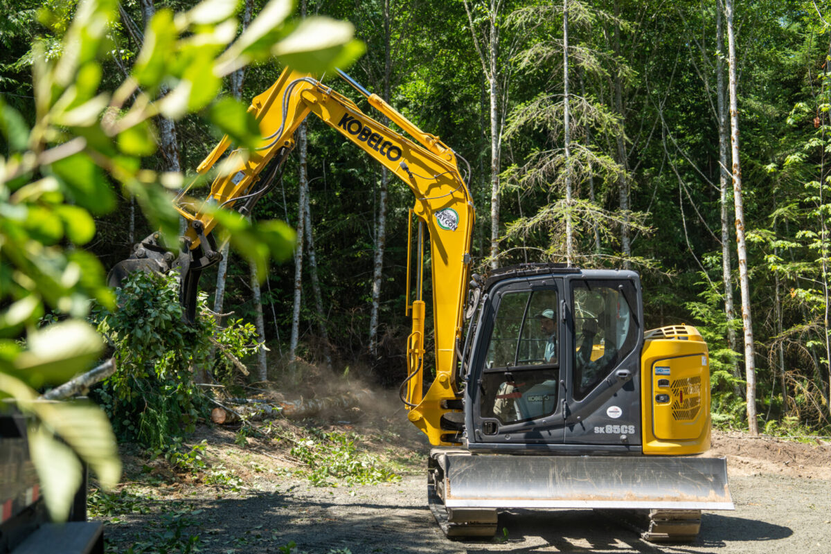Cinematic photo of Kobelco SK85 clearing land