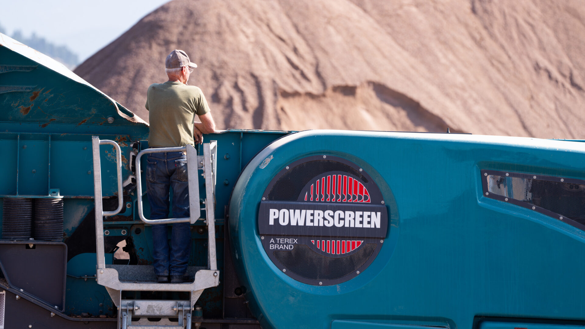 Man on top of Powerscreen crusher